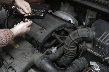 car mechanic fixes the car engine clipart