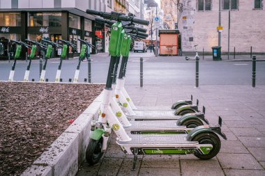 Cologne, Germany - December, 2019: E-mobility in Germany: discarded electric scooters near a train station in Cologne. clipart