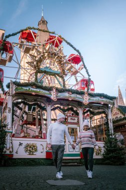 Genç çift, şehir gezisi sırasında Köln Almanya 'daki Noel pazarını, Noel pazarındaki kadın ve erkekleri ziyaret ediyor.