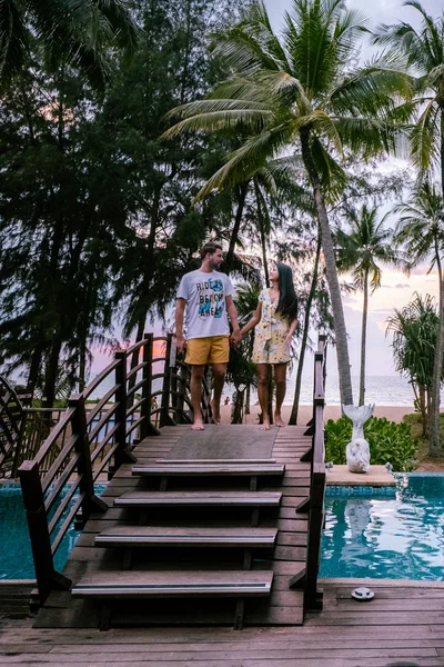 Couple regardant coucher de soleil sur la plage et la piscine d'un complexe de luxe en Thaïlande Khao Lak — Photo