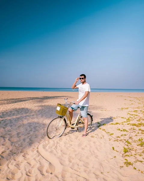 Kumsalda bisikletle poz veren genç adamlar Khao Lak plajı Tayland — Stok fotoğraf