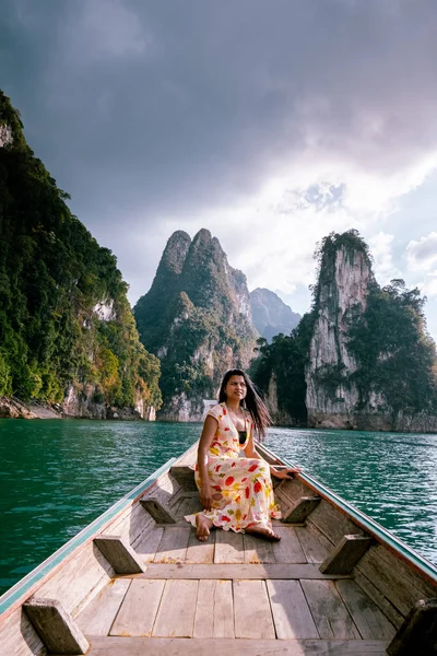 Khao Sok national park Cheow Lan Dam, Ratchaprapha Dam or Rajjaprabha Dam at Suratthani, Thailand couple on vacation