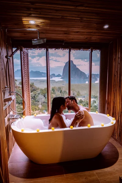 Paar op huwelijksreis vakantie, Badkuip met uitzicht over de baai van Phangnga baai, Luxe houten badkamer tijdens zonsondergang Thailand Azië — Stockfoto