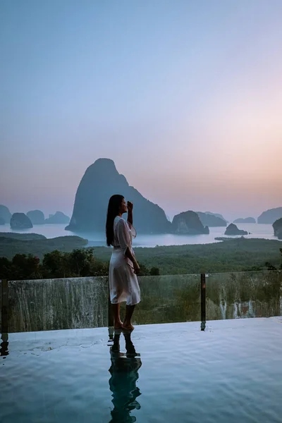 Phangnga Bay Thailand, woman on the edge of an swimming pool watching sunrise Thailand infinity pool — 스톡 사진