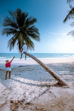 Thung Wua Laen beach Chumphon Thailand, couple on the beach by palm tree hanging on the white beach 