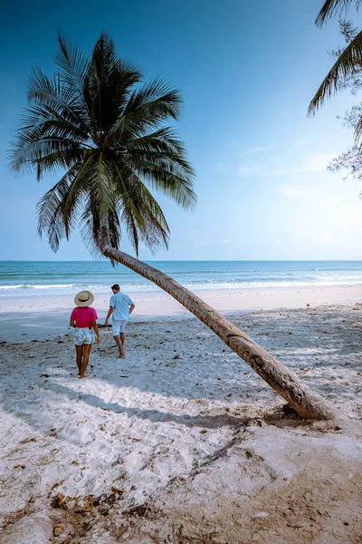 타이에서 휴가를 보내고 있는 부부와 함께 해변에 매달려 있는 야자수인 와과 야자 — 스톡 사진