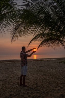 Chumphon Thailand, guywatching sunset on the beach in Thailand, men on the beach