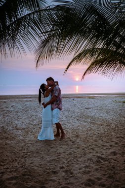Chumphon Thailand, couple watching sunset on the beach in Thailand