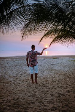 Chumphon Thailand, guywatching sunset on the beach in Thailand, men on the beach