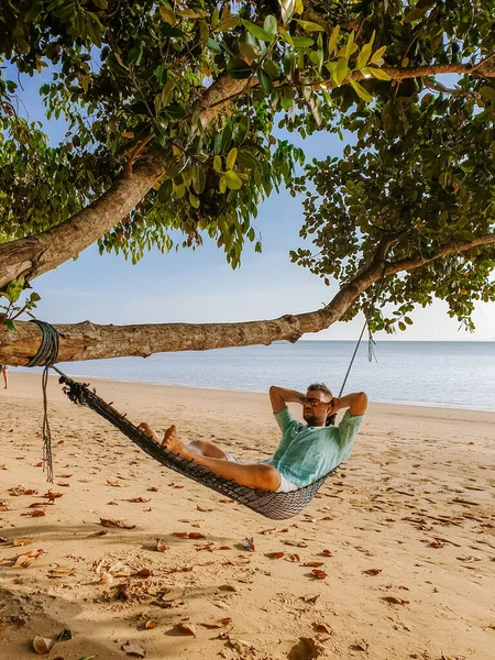 Hammock on the beach Krabi Thailand, guy in swing on Ao Nang beach Thailand Krabi — Stock Photo, Image