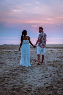 Chumphon Thailand, couple watching sunset on the beach in Thailand