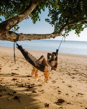 Hammock on the beach Krabi Thailand,woman in swing on Ao Nang beach Thailand Krabi