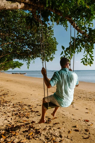 Hammock on the beach Krabi Thailand, guy in swing on Ao Nang beach Thailand Krabi — Stock Photo, Image