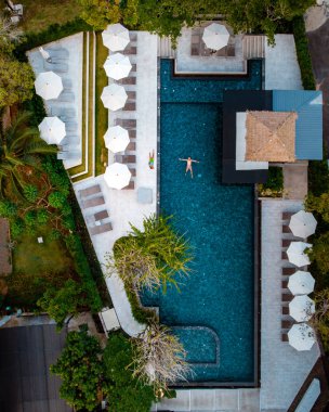 top view swimming pool, drone view pool, couple in swimming pool during vacation 