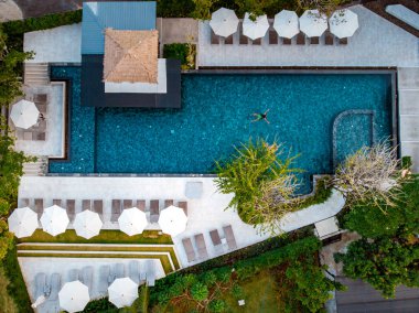 top view swimming pool, drone view pool, couple in swimming pool during vacation 