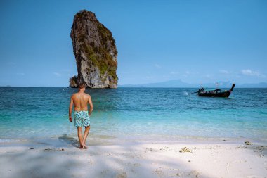 men in swim short on the beach, Koh Poda Krabi Thailand, white beach with crystal clear water in Krabi Thailand