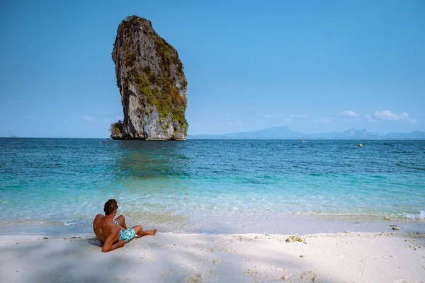 men in swim short on the beach, Koh Poda Krabi Thailand, white beach with crystal clear water in Krabi Thailand