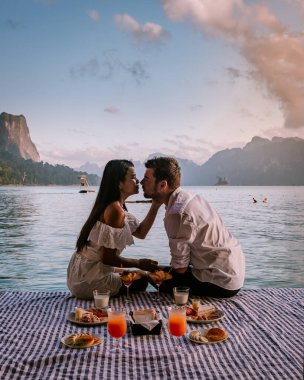 Phangnga Bay during sunrise, couple watching sunrise at the viewpoint Samet Nang Shee Thailand Phangnga province