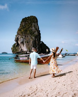 couple on a 4 Island trip in Krabi visit Railay beach, tropical Island men and woman in swimwear on the beach in Thailand clipart