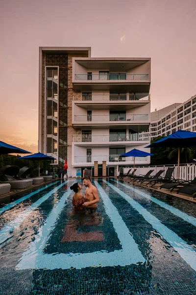 Couple in swimming pool during a luxury vacation in Thailand, men and woman at luxury hotel resort in Thailand holiday in Asia — Zdjęcie stockowe