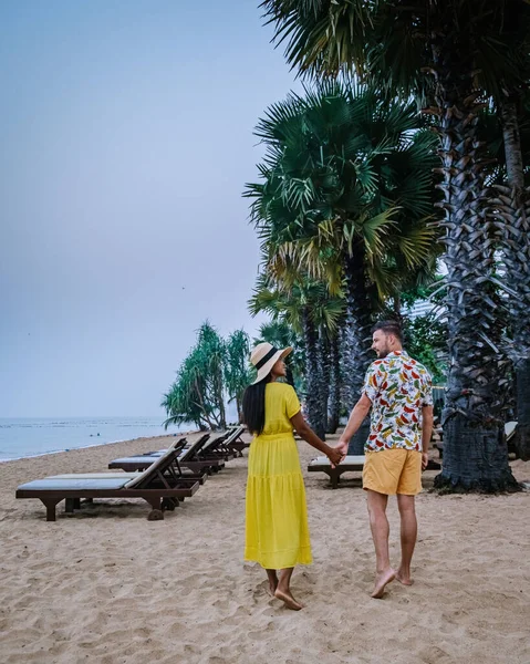 NaJomtien Pattaya Thailand, couple men and woman walking on the beach during sunrise in Pattaya Thailand — Stockfoto