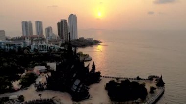 Skyline of Pattaya Thailand with wooden old historical temple during sunset Pattaya Thailand