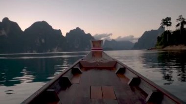 Longtail boat at the lake of Khao Sok Thailand, long tail wooden boat at the lake during sunset Khao Sok Lake