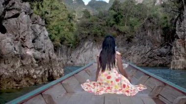 Khao Sok Thailand, woman on vacation in Thailand, girl in longtail boat at the Khao Sok national park Thailand