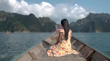 Khao Sok Thailand, woman on vacation in Thailand, girl in longtail boat at the Khao Sok national park Thailand