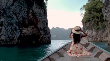 Khao Sok Thailand, woman on vacation in Thailand, girl in longtail boat at the Khao Sok national park Thailand