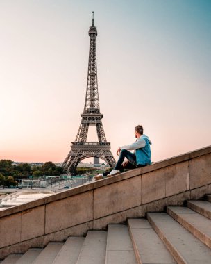 young men watching Eiffel tower in Paris. guy tourist visiting Paris France by eiffel tower