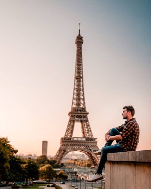 young men watching Eiffel tower in Paris. guy tourist visiting Paris France by eiffel tower