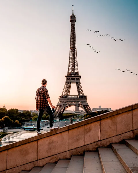 young men watching Eiffel tower in Paris. guy tourist visiting Paris France by eiffel tower