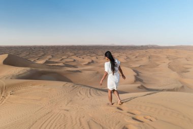 Dubai dessert sand dunes, couple on Dubai desert safari,United Arab Emirates, woman vacation in Dubai