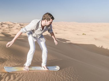 Dubai dessert sand dunes, couple on Dubai desert safari,United Arab Emirates, men on vacation in Dubai Emirates