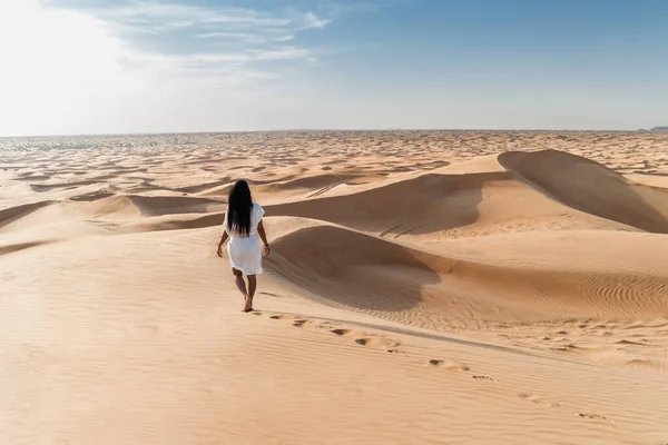 Dubai dessert sand dunes, couple on Dubai desert safari,United Arab Emirates, woman vacation in Dubai