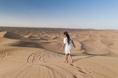 Dubai dessert sand dunes, couple on Dubai desert safari,United Arab Emirates, woman vacation in Dubai