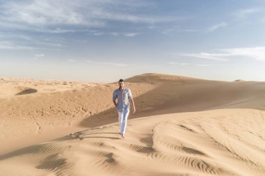 Dubai dessert sand dunes, couple on Dubai desert safari,United Arab Emirates, men on vacation in Dubai Emirates