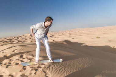 Dubai dessert sand dunes, couple on Dubai desert safari,United Arab Emirates, men on vacation in Dubai Emirates