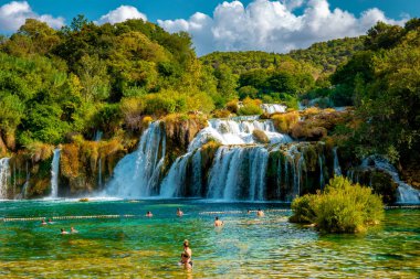 KRKA waterfalls Croatia September , krka national park Croatia on a bright summer evening with people relaxing in the water