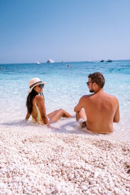 Sardinia Orosei coast Italy, woman on vacation at the Island of Sardinia on a boat trip to all the white pebble beaches some of the most beautiful beaches in Europe 