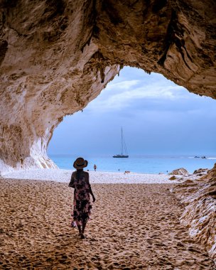 Sardinia Orosei coast Italy, woman on vacation at the Island of Sardinia on a boat trip to all the white pebble beaches some of the most beautiful beaches in Europe 