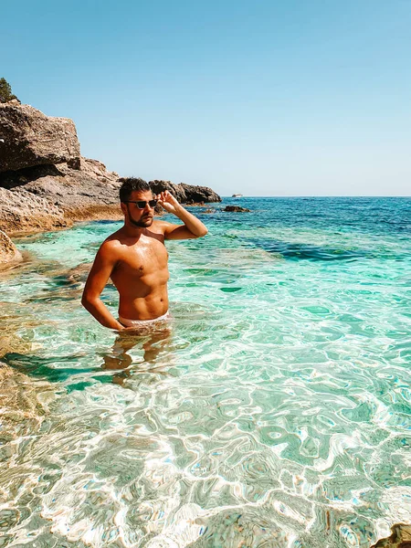 Sardinia Orosei coast Italy, guy on vacation at the Island of Sardinia on a boat trip to all the white pebble beaches some of the most beautiful beaches in Europe — Stok fotoğraf