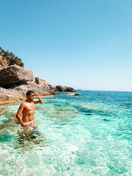 Sardegna Costa di Orosei Italia, ragazzo in vacanza all'Isola di Sardegna in barca verso tutte le spiagge di ciottoli bianchi alcune delle spiagge più belle d'Europa — Foto Stock