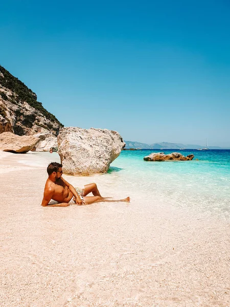 Sardinia Orosei coast Italy, guy on vacation at the Island of Sardinia on a boat trip to all the white pebble beaches some of the most beautiful beaches in Europe — ストック写真