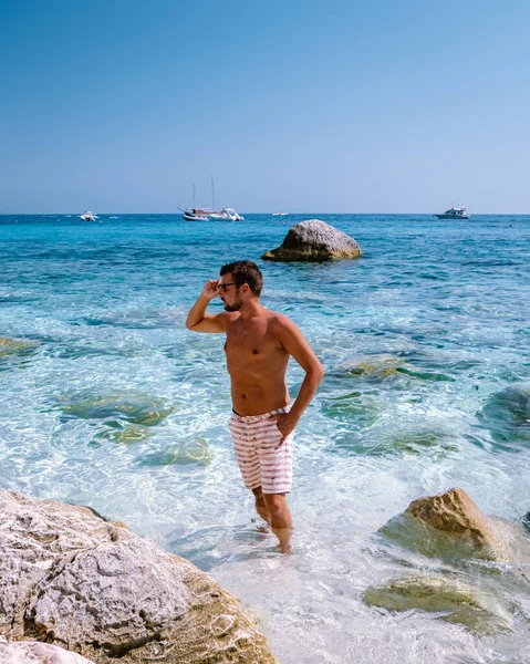 Sardinia Orosei coast Italy, guy on vacation at the Island of Sardinia on a boat trip to all the white pebble beaches some of the most beautiful beaches in Europe — Zdjęcie stockowe