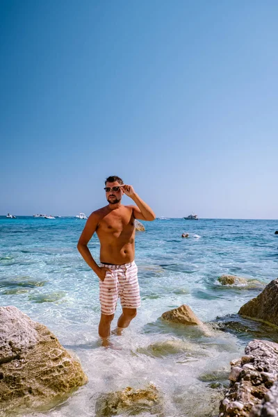 Cerdeña costa de Orosei Italia, chico de vacaciones en la isla de Cerdeña en un viaje en barco a todas las playas de guijarros blancos algunas de las playas más bellas de Europa — Foto de Stock