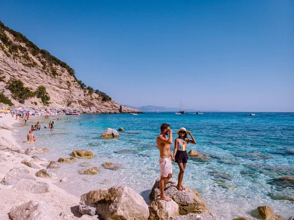 Sardinia Orosei coast Italy, men and woman, young couple adult on vacation at the Island of Sardinia on a boat trip to all the white pebble beaches some of the most beautiful beaches in Europe — Zdjęcie stockowe