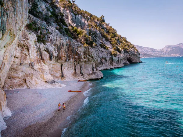 Sardinia Orosei coast Italy, men and woman, young couple adult on vacation at the Island of Sardinia on a boat trip to all the white pebble beaches some of the most beautiful beaches in Europe — Stockfoto