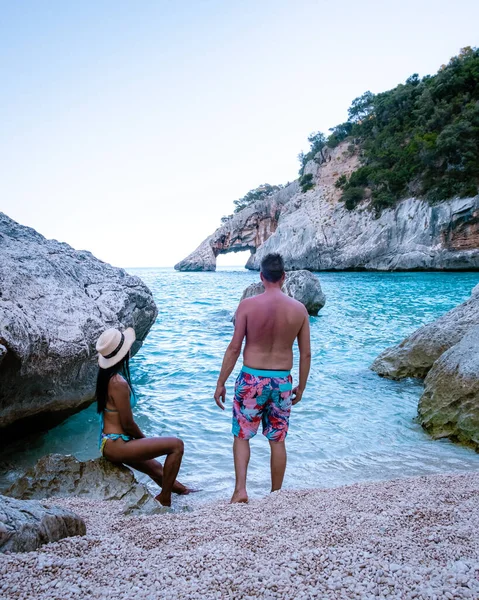 Sardinia Orosei coast Italy, men and woman, young couple adult on vacation at the Island of Sardinia on a boat trip to all the white pebble beaches some of the most beautiful beaches in Europe — Stockfoto